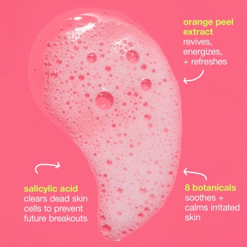 Pink liquid with bubbles, highlighting benefits of orange peel extract, salicylic acid, and botanicals for skin care.
