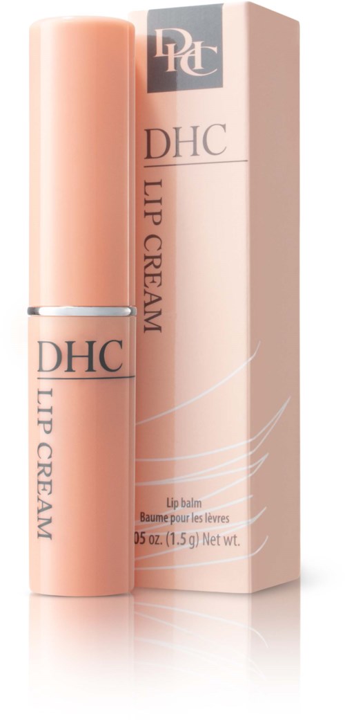 Een klein perzikkleurig lippenbalsemtubetje naast een bijpassende doos met DHC Lip Cream.