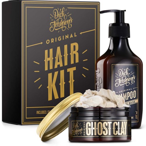 Et hårplejesæt med shampoo, ghost clay og en boks mærket Dick Johnson's. Produkterne er sorte og guld.