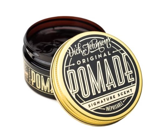 En boks av Dick Johnson's Original Pomade med svart lokk, som viser en etikett med vintage-stil tekst og design.