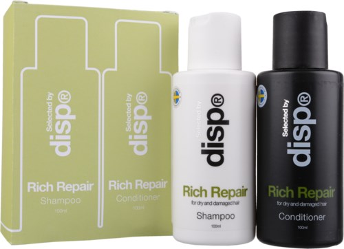 Ett set hårvårdsprodukter med schampo och balsam i svart och vitt, med lådor märka 'Rich Repair.'