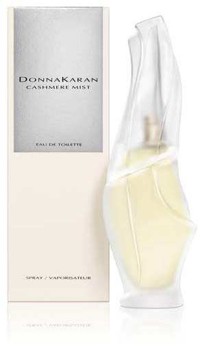A perfume bottle with a sleek, curved glass design next to a white box labeled 'DONNA KARAN CASHMERE MIST.'