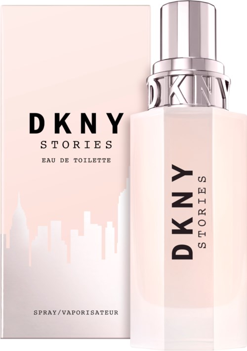 Ein Parfühndose und Verpackung, hellrosa, mit 'DKNY STORIES' geschrieben. Skyline-Silhouette ist sichtbar.