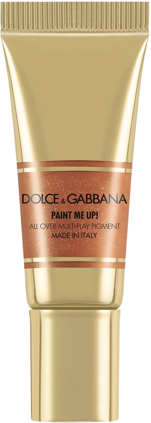 Gullfarget tube med brunt og gullfarget etikett, står "DOLCE & GABBANA PAINT ME UP!" og "MADE IN ITALY."
