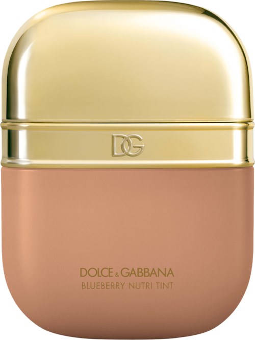 A small, rounded container with a gold cap and pink body. It is a lipstick or makeup product from Dolce & Gabbana.