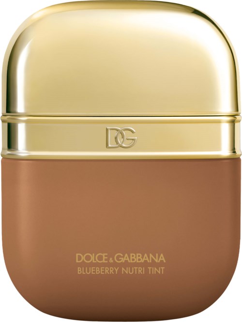 A small, rounded container with a gold top and a brown bottom, labeled Dolce & Gabbana blueberry tinted product.