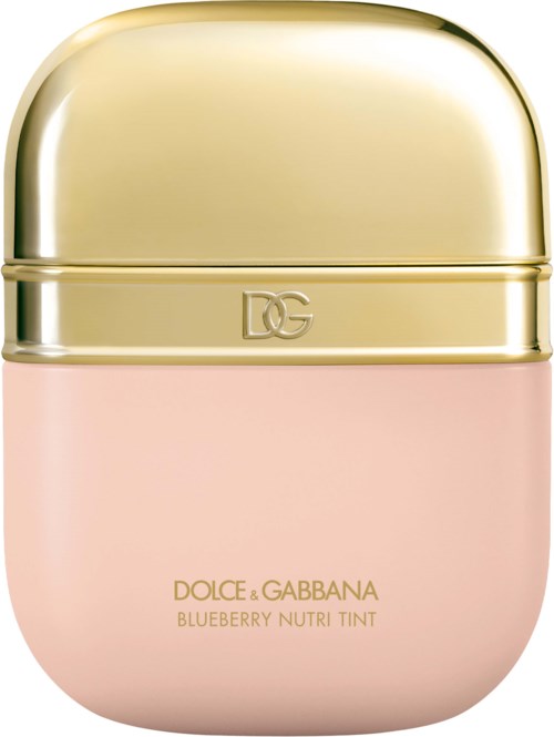 A small, pink cosmetic container with a shiny, gold lid and gold text saying 'DOLCE & GABBANA BLUEBERRY NUTRI TINT.'