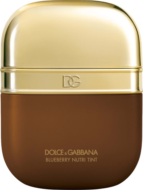 A compact container with a shiny gold top and brown bottom, labeled Dolce & Gabbana blueberry Nutri Tint.