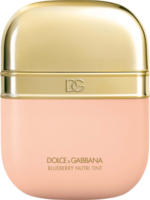 A pastel pink container with a shiny gold cap, labeled Dolce & Gabbana Blueberry Nutri Tint.