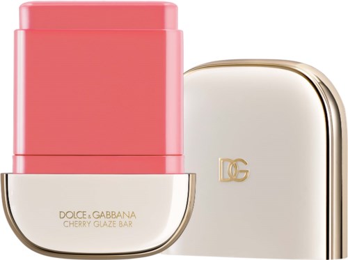 En leppestiftbeholder med rosa farge og beige lokk med gull D&G-logo.