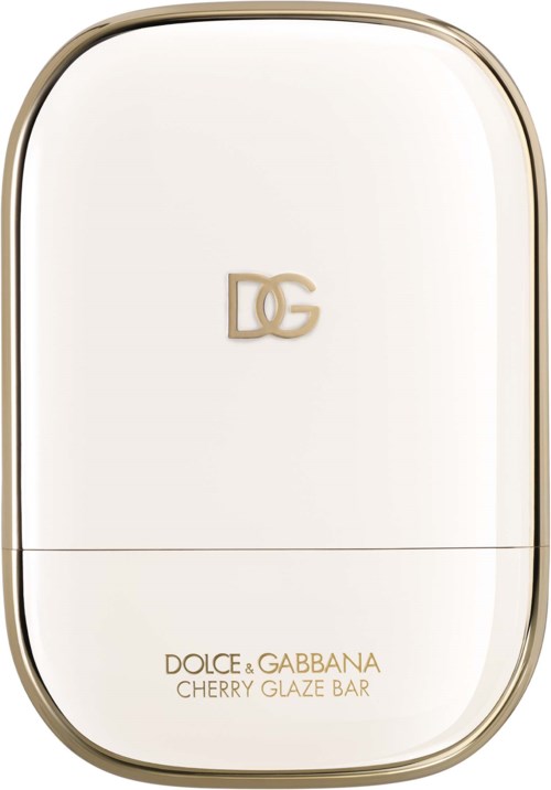 En hvit beholder med gullkant og gullig Dolce Gabbana-logo, merket Cherry Glaze Bar.