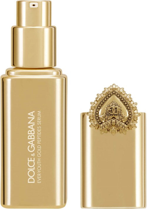 Złota butelka dobrej jakości kremu lub serum Dolce & Gabbana z dekoracyjną nakrętką i logo.