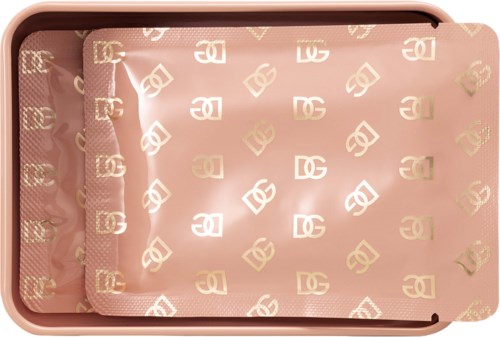 A pink tray with a pattern of gold and white logos inside. The tray looks shiny and decorative.