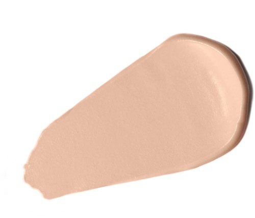 Beige nestemäärä levitetty pisaran muotoon valkoiselle taustalle, mahdollisesti meikkivoide tai ihon meikki.
