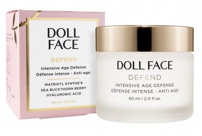 A skincare jar and box labeled 'DOLL FACE DEFEND' for anti-age and hyaluronic acid treatment.