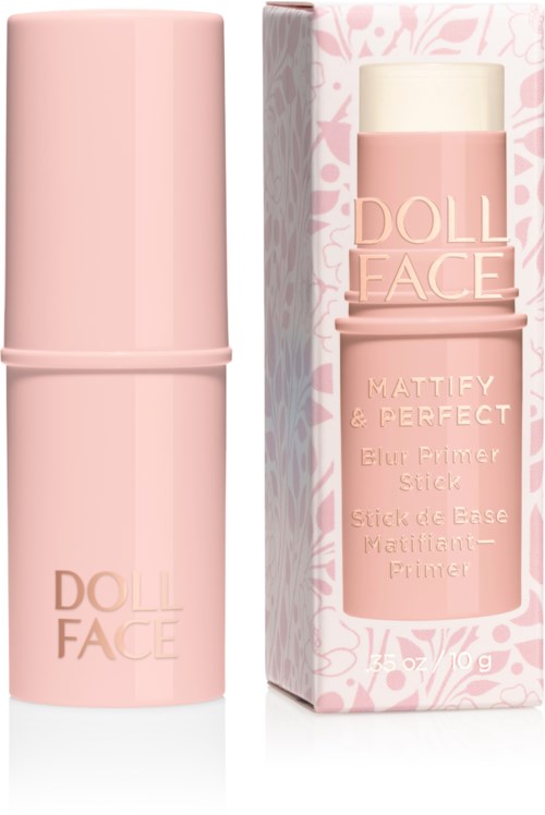 A pink makeup stick with a box, labelled 'DOLL FACE', standing upright. The box has pink floral design.