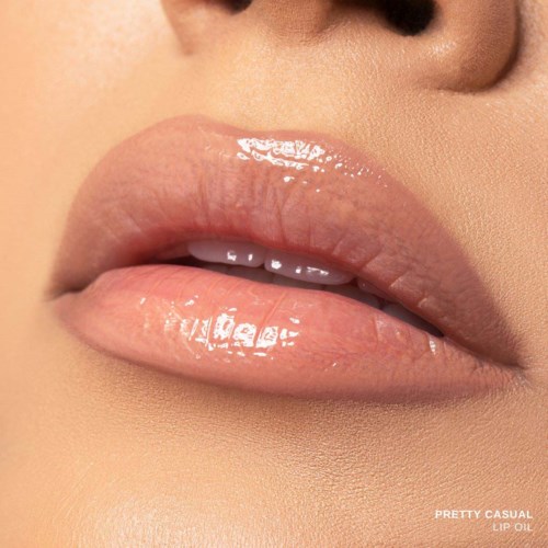 Close-up of glossy, nude lips with a hint of shine and smooth skin around.