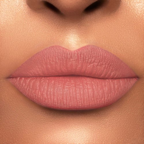 Close-up van volle lippen met matte roze lippenstift en gladde huid eromheen.