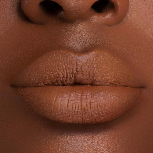Close-up of full, dry lips and part of the nose, with textured skin visible around the lips.