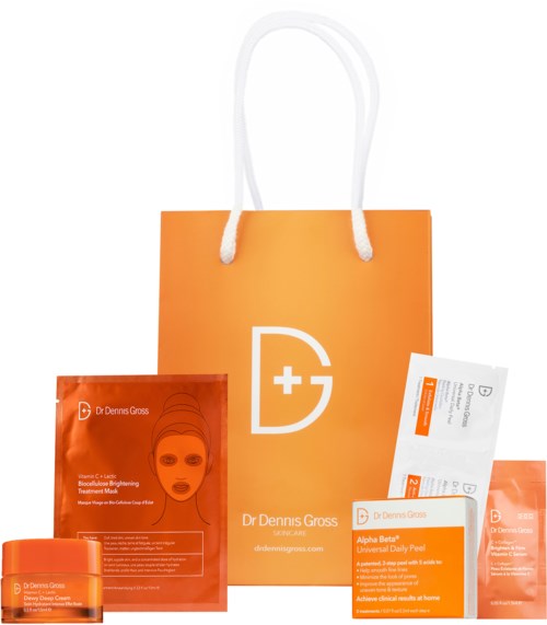 Skincare products inside an orange bag with white handles, featuring the Dr Dennis Gross logo. Includes face mask packages.