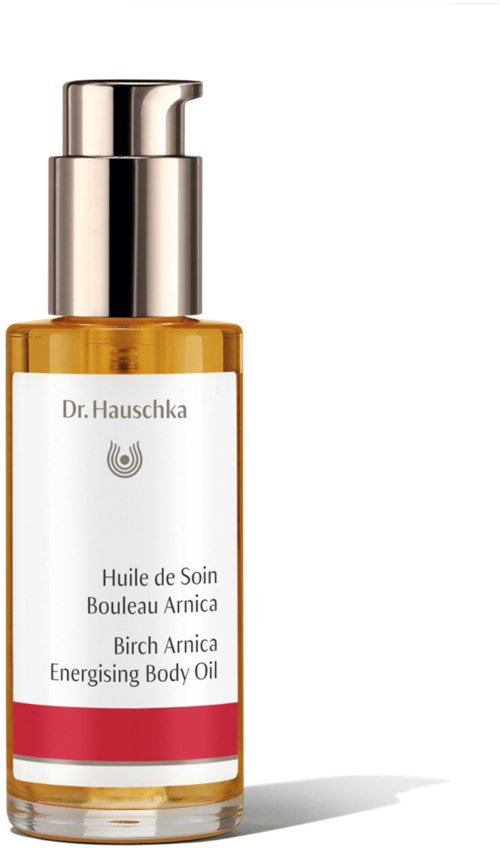 En liten flaska med kroppsolja med pump, märkt 'Dr. Hauschka Birch Arnica Energising Body Oil.'