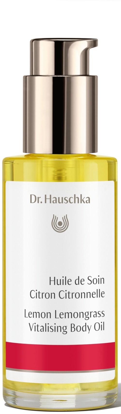 En gjennomsiktig flaske med gul væske og en sølvpumpe, merket sitron kropps olje, av Dr. Hauschka.