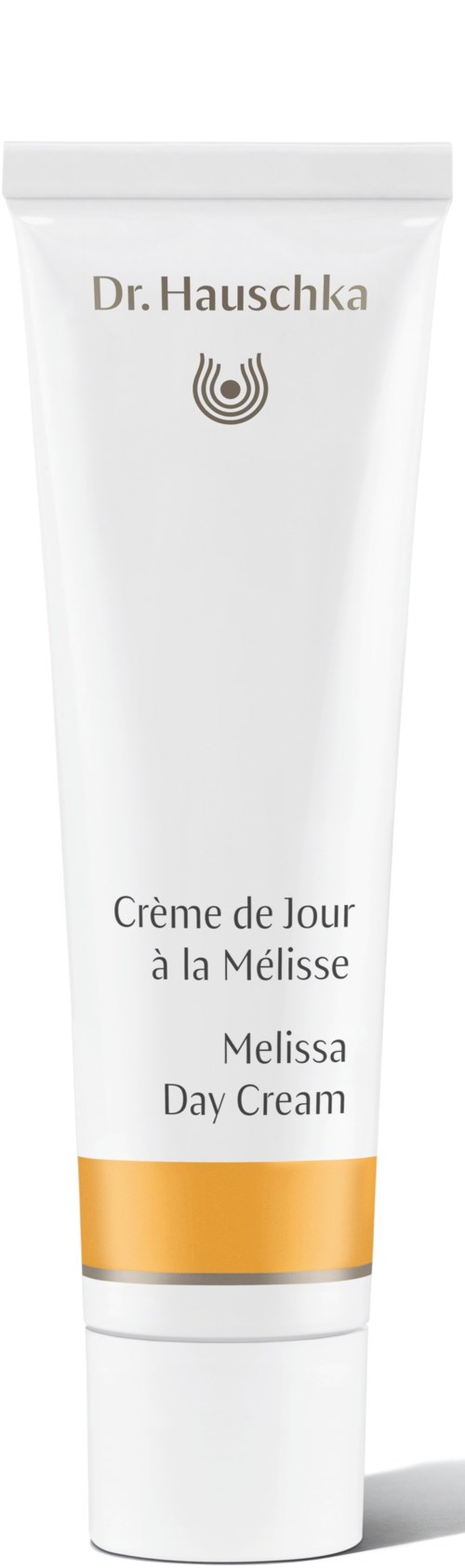 En vit tub med Dr. Hauschka Melissa Day Cream med guldkant, märkt på flera språk.