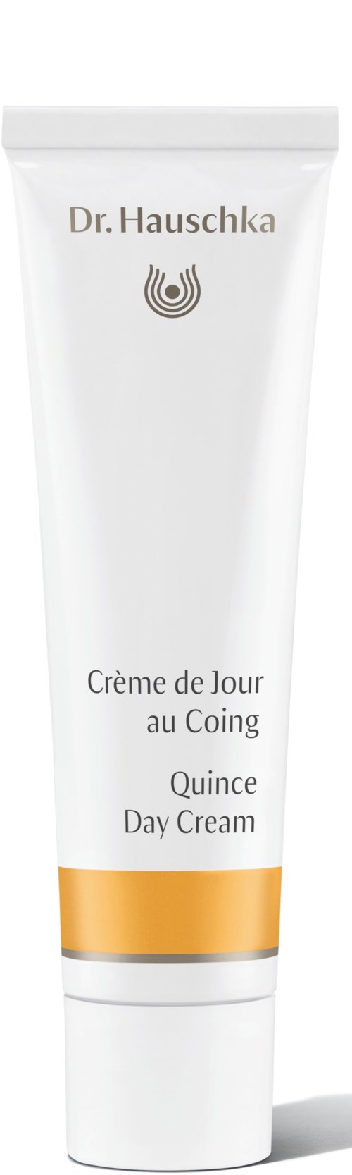 En vit tub med gyllene band, märkt Dr. Hauschka, Quince Day Cream, för hudvård.
