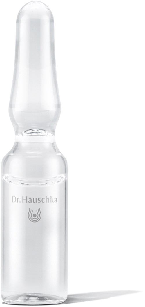En liten glasflaska med smal spets, märkt 'Dr. Hauschka'. Det verkar vara en kosmetisk eller medicinsk produkt.