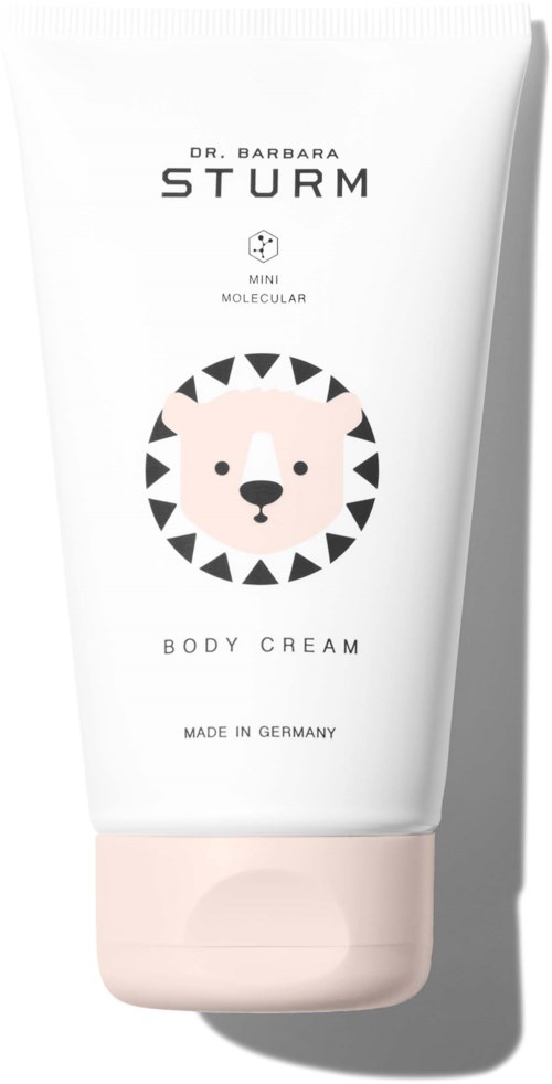 A white tube with a bear face logo, text about body cream, and a light pink cap.