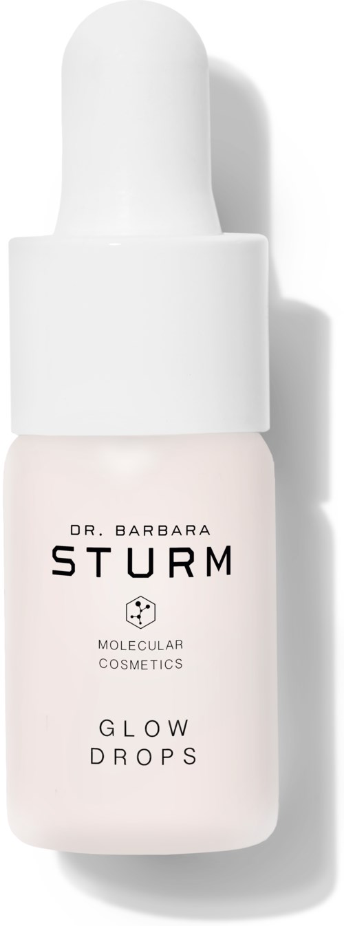 Pieni valkoinen pullo tiputimella, etiketti 'Dr. Barbara Sturm Glow Drops' ihonhoitoon.