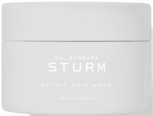Et hvitt glass med tekst om en reparasjons hårmaske av Dr. Barbara Sturm, laget i Tyskland.