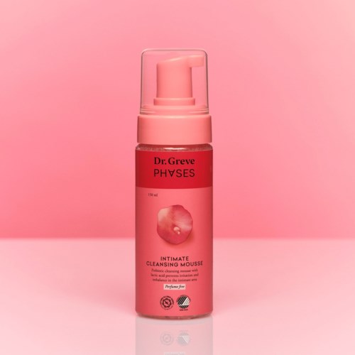 Pink bottle of Dr. Greve PHAVES Intimate Cleansing Mousse against pink background.