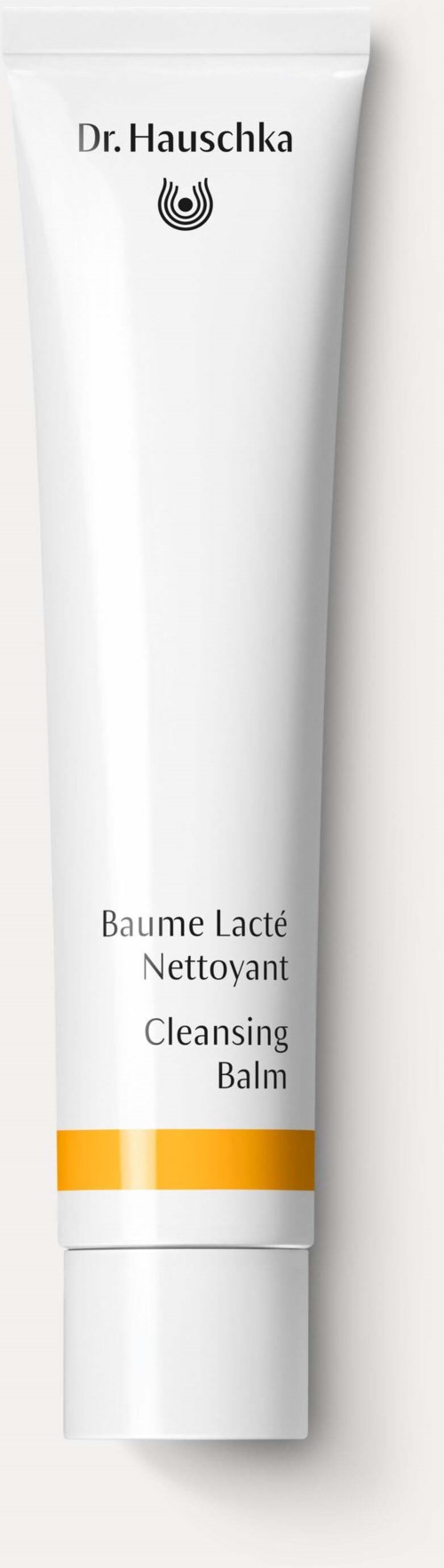 Een witte tube met reinigingsbalsem met gele en witte strepen, gelabeld 'Dr. Hauschka' en 'Cleansing Balm'.