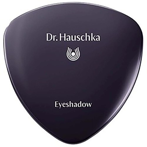 A black eyeshadow compact labeled 'Dr. Hauschka' with a logo in the center.