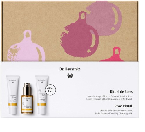 A skincare set with facial cream, toner, and cleansing milk inside a white box, decorated with pink and purple ornaments.