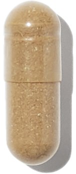 Ett beige kapselliknande piller med blank, slät yta och en delningslinje i mitten.