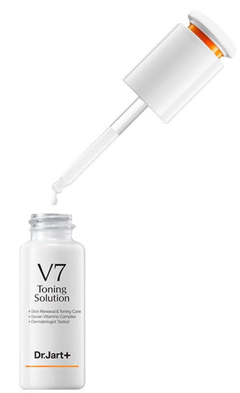 En vit flaska märkt 'V7 Toning Solution' med en pipettlock, och en droppe vätska faller ner i den.