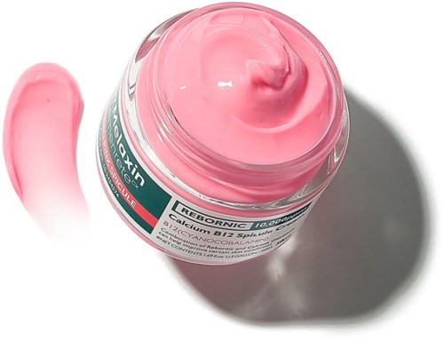 Een roze pot ReboNox calcium B12-supplement met wat crème bovenop en een vlek ernaast.