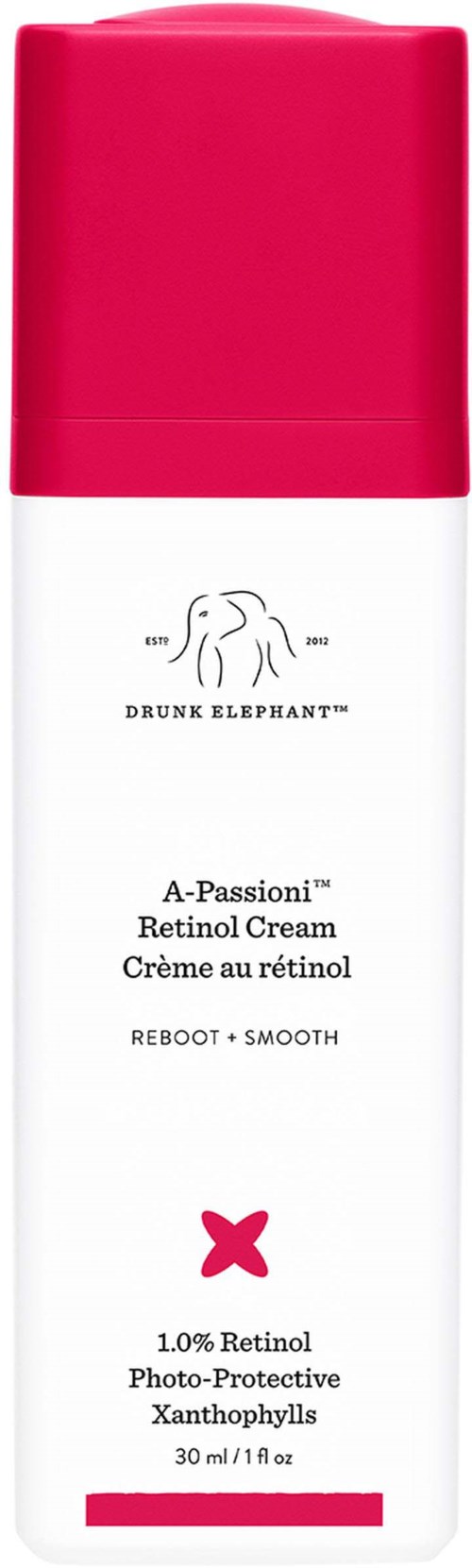 En flaska med Drunk Elephant Retinol Cream med en rosa topp, vit kropp och text om hudvårdsingredienser.
