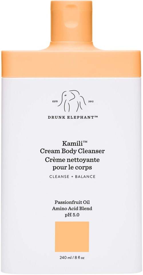 En vit och persikofärgad flaska med etikett 'Drunk Elephant Kamili Cream Body Cleanser' och en elefantlogga.