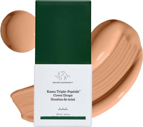 En vit förpackning med gröna detaljer och logo, framför beige flytande foundation och liten klick.