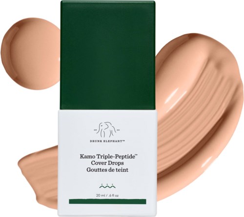 Grön och vit förpackning för Drunk Elephant Kamo Triple-Peptide Cover Drops med en ljus beige foundation swatch bakom.
