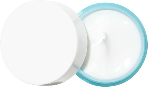 En åpen beholder med hvit krem eller lotion, og et lukket hvitt lokk i nærheten.