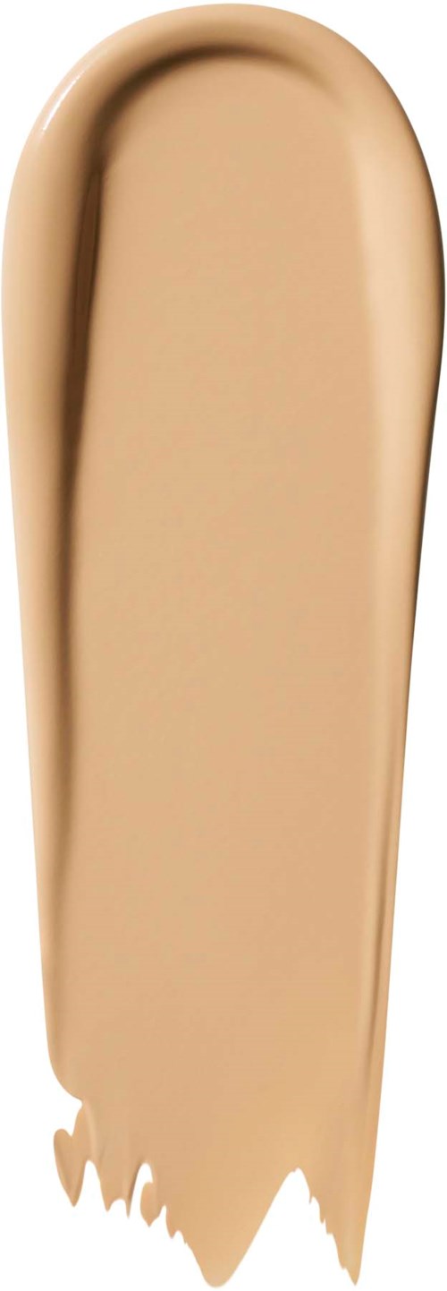 En beige sminkgrund på ett vitt bakgrund, rundad och långsträckt form.