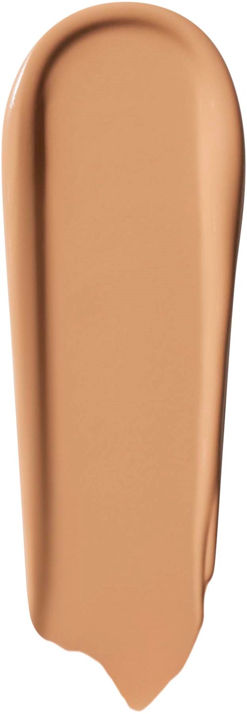 Ett beige lager av flytande foundation på vit bakgrund. Det sprids i en slät, förlängd form.