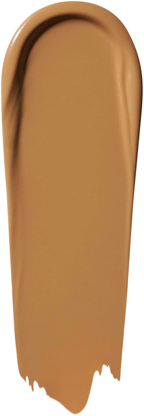 En beige sminkprøve med en kurvet form og jevn, kremaktig tekstur.