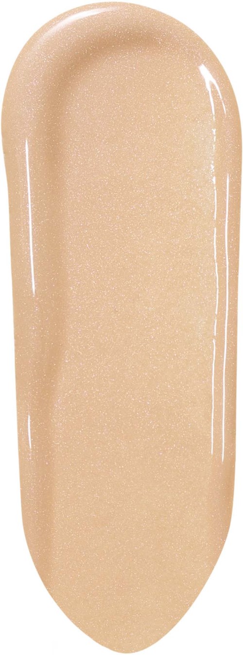 Et beige ovalobjekt med glatt, skinnende overflate, ser ut som en klatt med krem eller foundation.