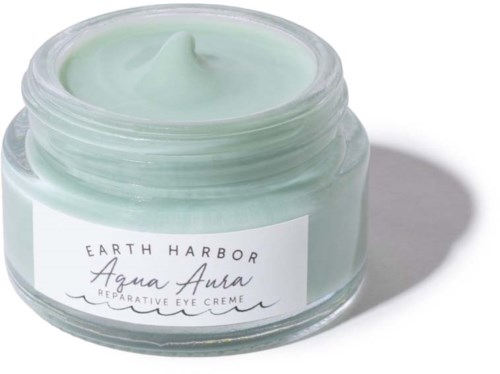 En liten glass med lysegrønn øyekrem fra Earth Harbor, merket 'Aqua Aura' for reparasjon.