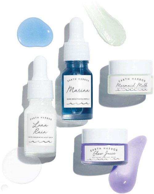 Hautpflegeflaschen mit verschiedenen Farbgele oder -cremes, beschriftet mit Marina, Luna Rain, Mermaid Milk und Glow Juice.